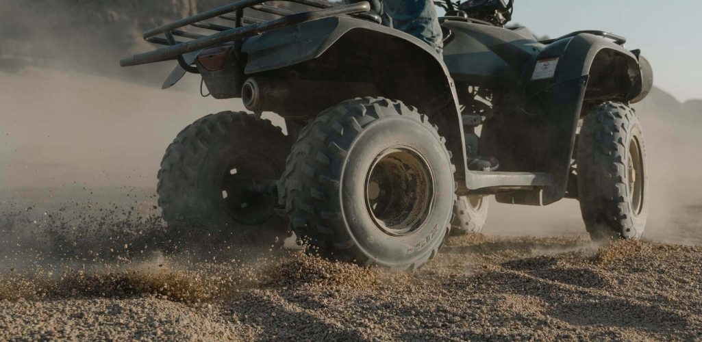 A person riding an ATV (All-terrain vehicles)