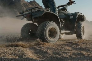 A person riding an ATV (All-terrain vehicles)