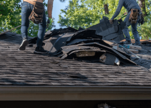 A group of people on the roof of a home caused by storm damage in Tulsa, OK