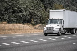 A white commercial truck on the road