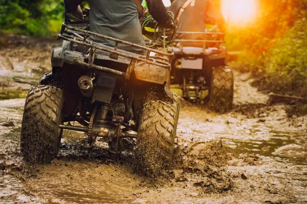 A group of people riding atvs in mud in Arkansas
