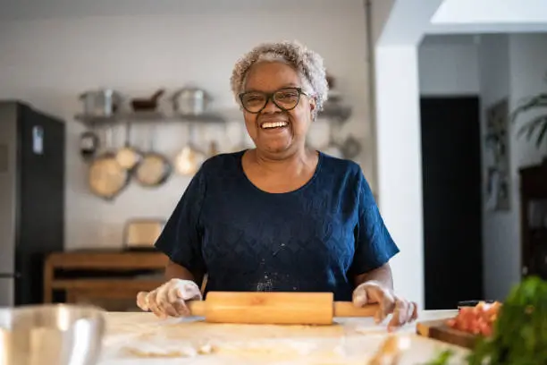 a woman smiling while baking