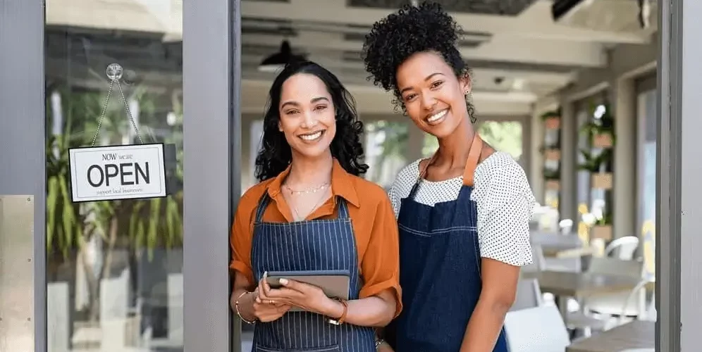 a couple of women wearing aprons