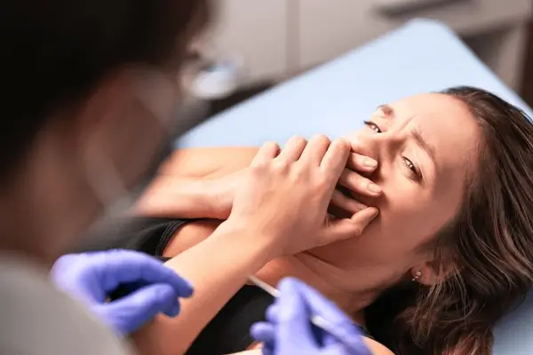 a woman lying on a bed with her mouth open