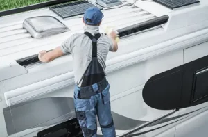 a man repairing an RV roof in Fayetteville, AR