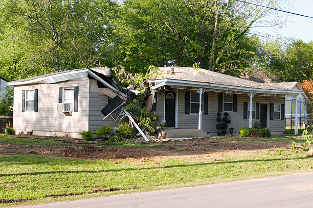 a house with a broken roof caused by a tornado