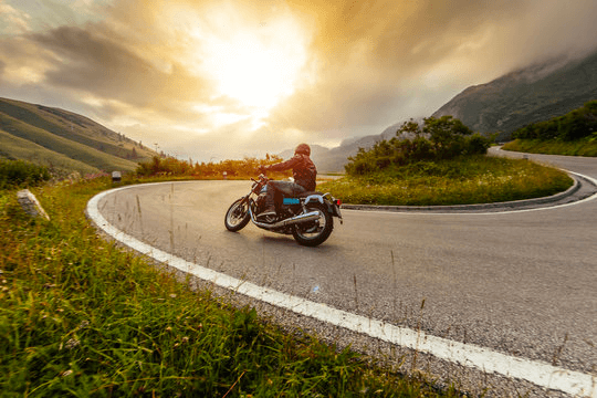 a person riding a motorcycle on a winding road