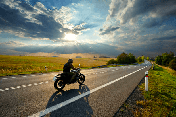 a man riding a motorcycle on a road