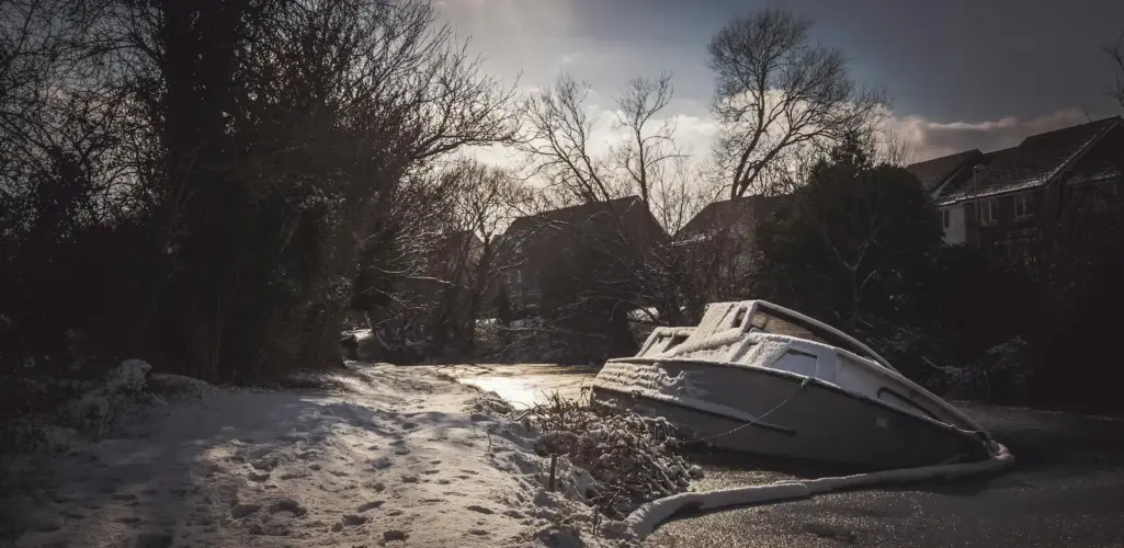 Boat covered and stored outdoors during winter