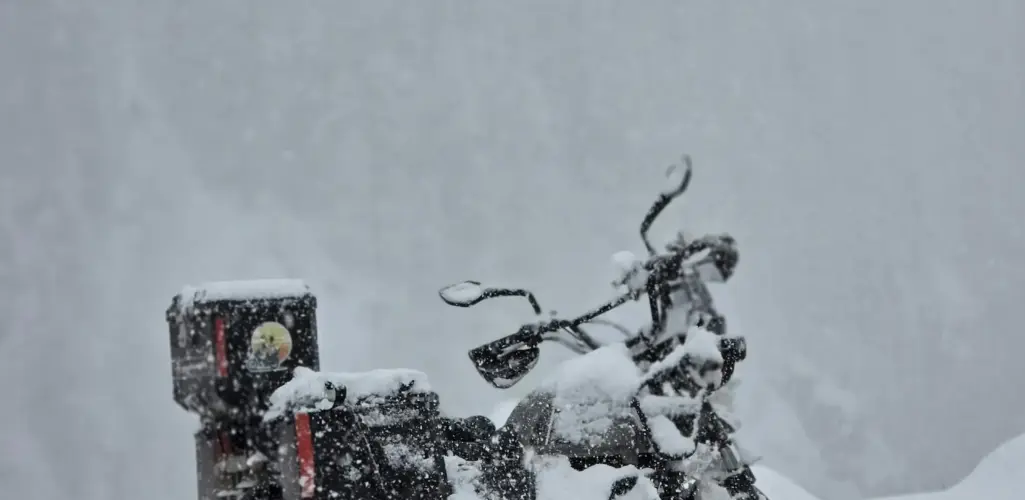 Motorcycle parked in a snowy place