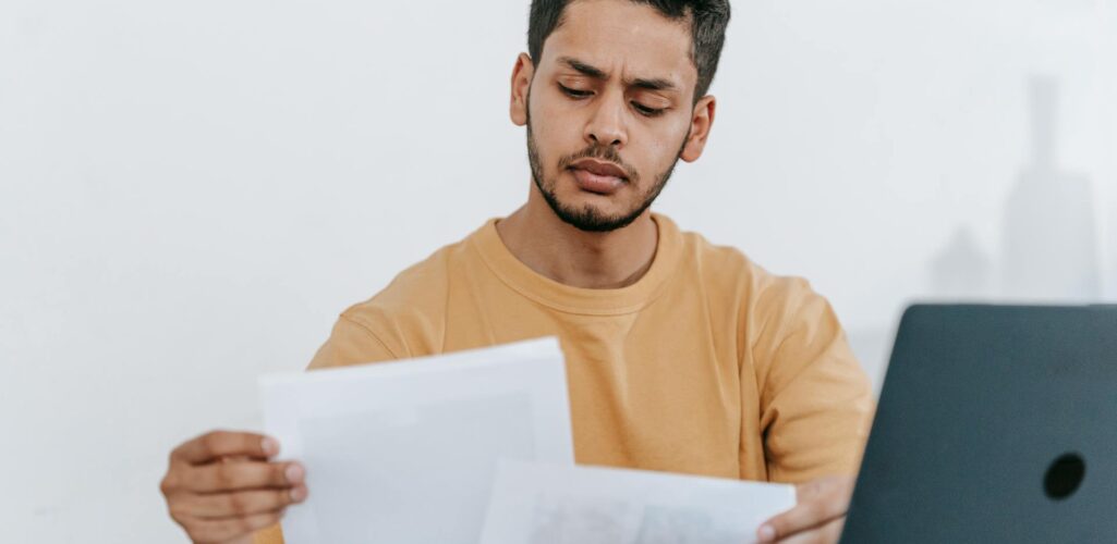 A man reviewing insurance policy limits, deductibles, and bundling options in Arkansas