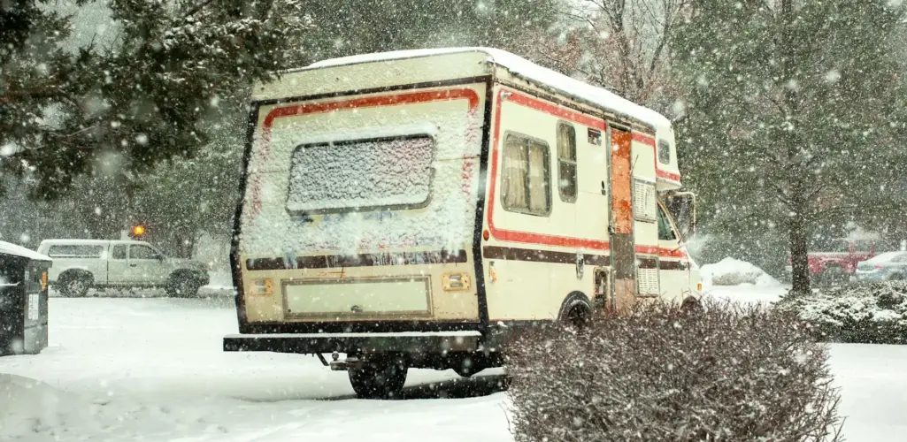 Recreational vehicle parked in snow during winter