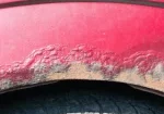 A close up of a car with rust damage