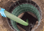 a person holding a hose in a hole