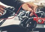 Technician Hands of car mechanic working in auto repair Service and Maintenance car battery