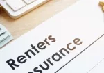a pen and renters insurance form on a desk